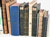 many books that are lined up on a shelf