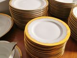 a lot of plates that are on a wooden table