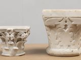 two white vases sitting next to each other on a table