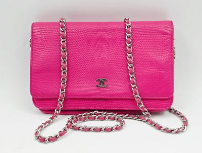 un sac à main rose avec une chaîne qui l'entoure et une autre chaîne qui l'entoure