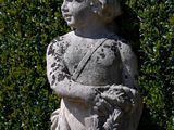 a statue of a boy holding a bird in his hands