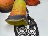 a bell and a pear on a table next to a picture frame