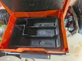 an orange tool box with two trays inside of it