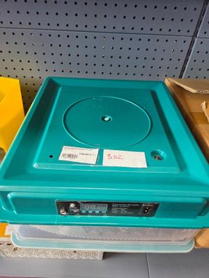 a blue plastic box with a cd player on top of it