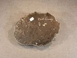 a rock with a tag on it sitting on a table
