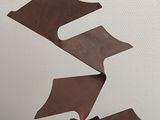 a metal sculpture that is on display in a room
