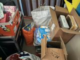 a pile of boxes sitting on the floor next to a chair