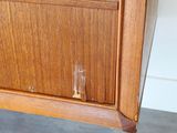 a close up of a wooden cabinet with a glass door