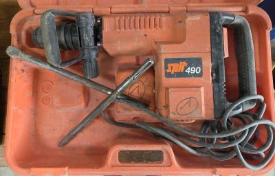 an orange box with a hammer and other tools in it