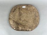 a stone with a tag on it sitting on a table