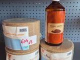 a bottle of alcohol sitting on top of two cans