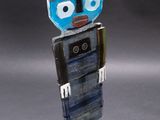 a sculpture of a robot made of glass and metal