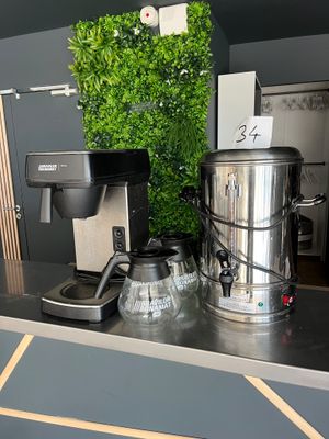 a picture of a coffee maker and a coffee pot on a counter