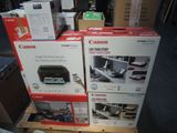 several boxes of canon printers are stacked on top of each other
