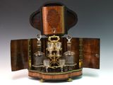 an old fashioned liquor set on a wooden stand