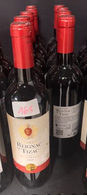 several bottles of wine are lined up on a shelf in a store