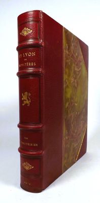 the book is red with gold trimmings on the front and sides of it