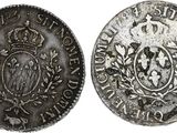 an old silver coin with a crown on the front and a crown on the back