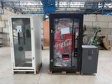 two vending machines sitting next to each other in a warehouse
