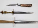three different types of knives are displayed on a white surface