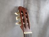 a close up of an acoustic guitar on a table