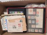 a box full of stamps and envelopes sitting on a table