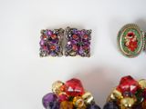 three pieces of jewelry sitting on top of a table next to each other