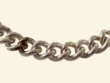 a close up of a silver chain on a white background