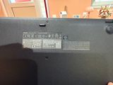 a person holding a laptop that has a battery on it