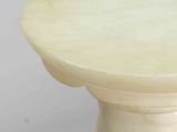 a close up of a table with a vase on top of it