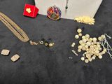 a close up of a necklace, bracelet, and other jewelry on a table