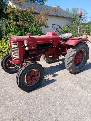 un tracteur rouge garé dans l'allée