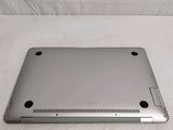 a silver laptop computer sitting on a white surface