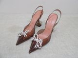 pair of women ' s brown shoes with bows on the toes