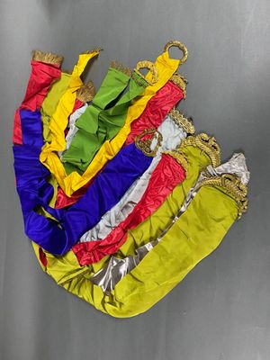five different colored bags hanging on a metal wall