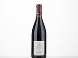 a bottle of red wine sitting on top of a table