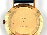 a gold wrist watch with a black leather band