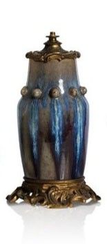 a blue and gold vase sitting on top of a table