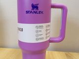 a plastic cup with a handle on a wooden table
