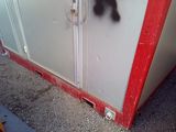 a red and white cabinet with a black cat on it