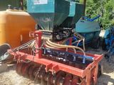 a tractor that is parked next to a trailer