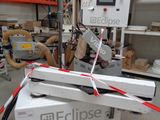 a machine that is cutting a piece of paper in a factory