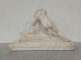 marble statue of a woman and a man sitting on a bench