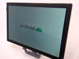 a tablet that is sitting on a stand with a logo on it