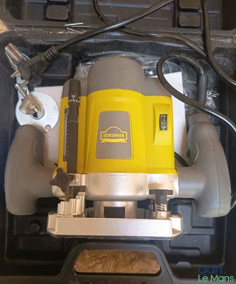 a yellow and black machine that is sitting in a box