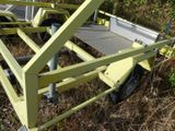 a yellow trailer that is sitting in the grass