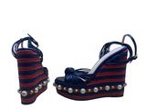 a close up of a pair of wedges with pearls on them