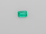 an emerald stone on a white surface
