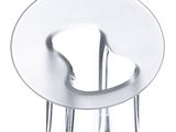 a glass sculpture of a chair with a red bead on it