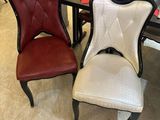 two chairs sitting next to each other in a room